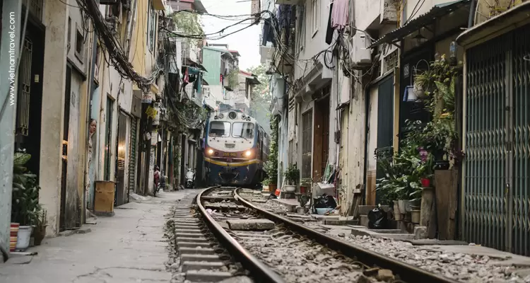 a Train running through an alley