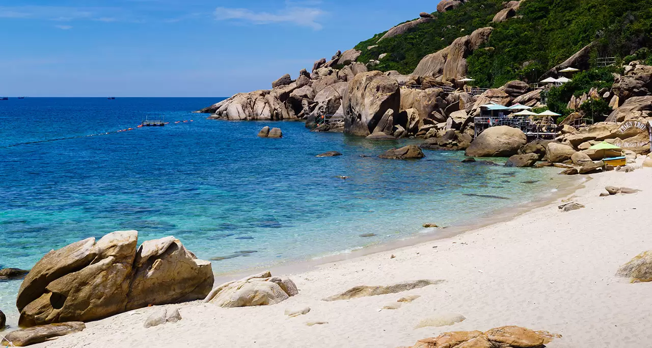 Rocks, sand and blue water at Binh Ba Island, Khanh Hoa