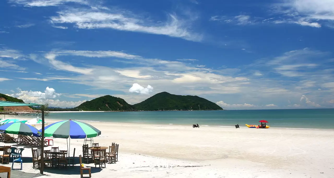 A relaxing spot on Minh Chau Beach with white sand, blue water, sun umbrellas and chairs