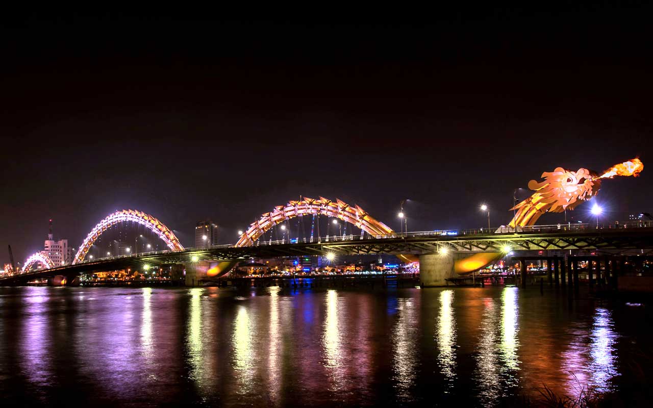 A spectacular view of the Dragon Bridge breathing fire at night in Da Nang city
