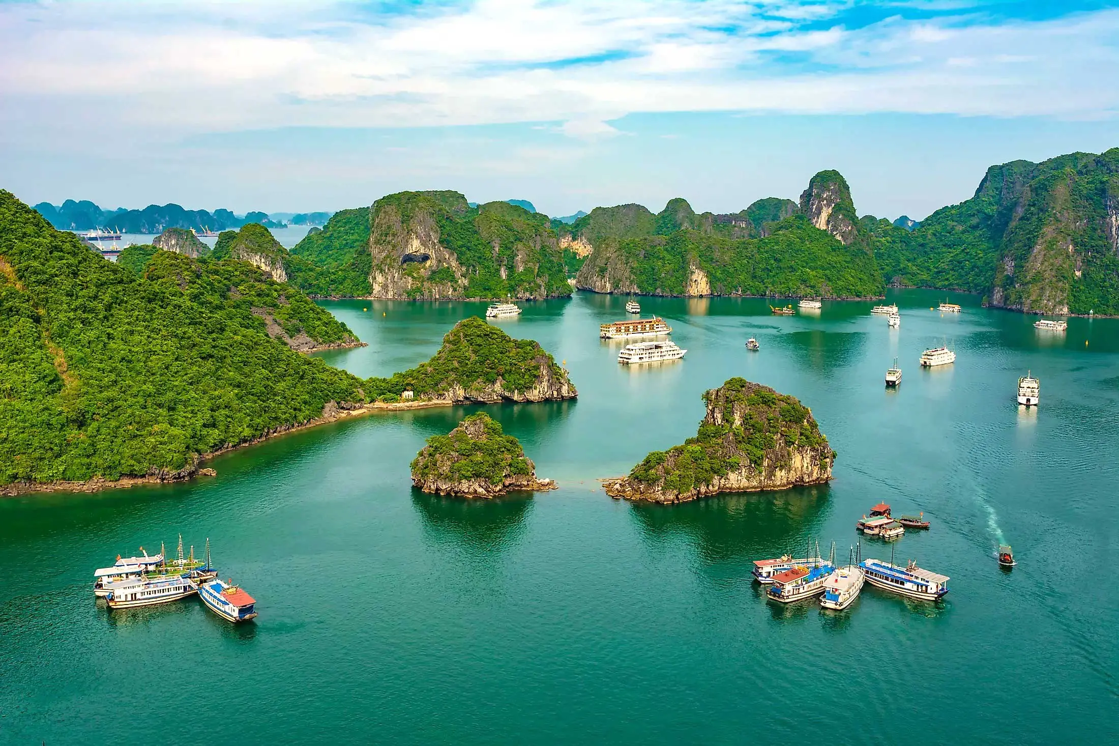 A scenic view of Halong Bay with limestone karsts and blue water in October