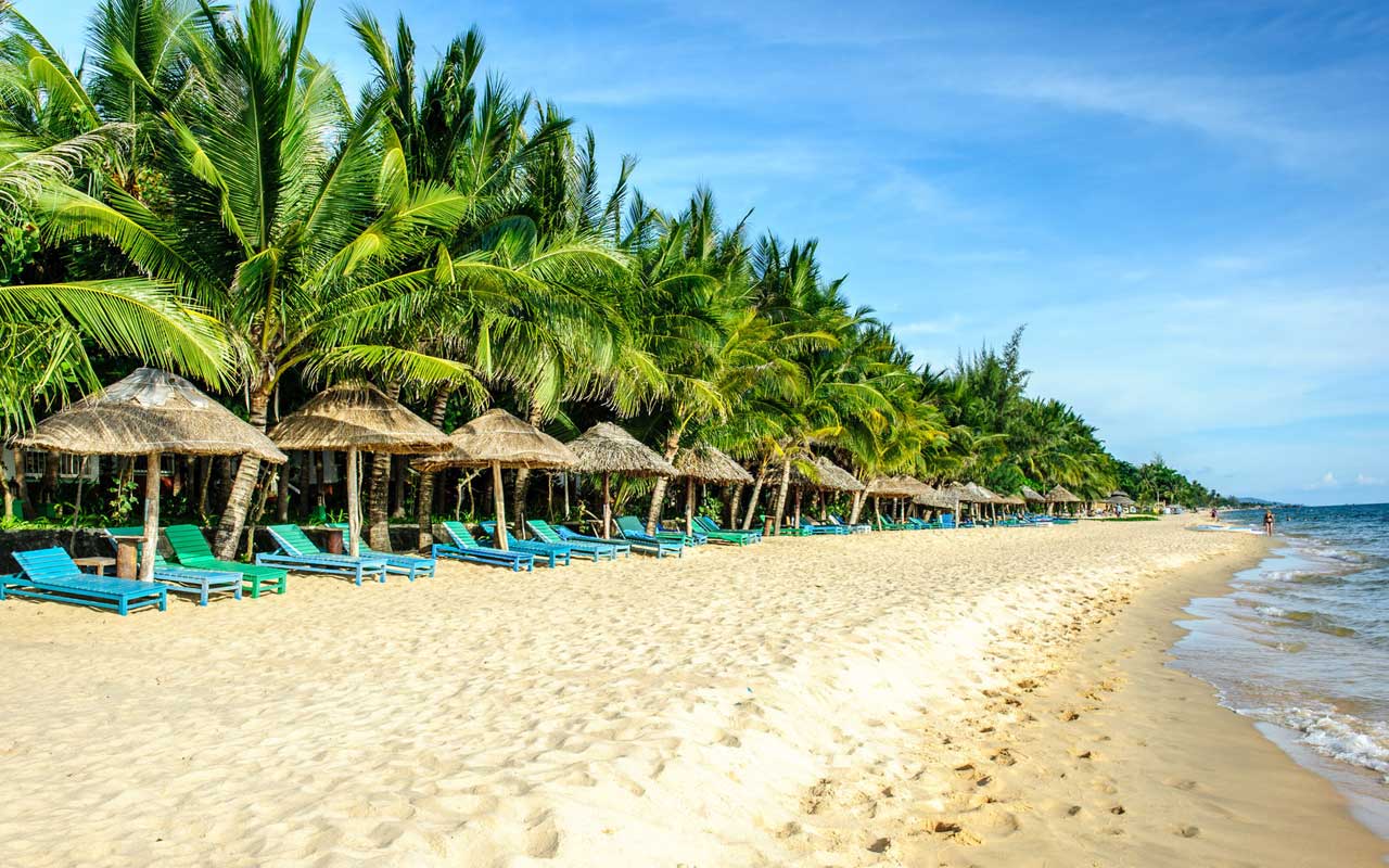 A sunny beach with clear blue water and white sand in Phu Quoc island