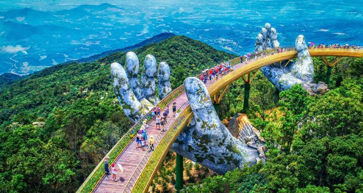 Breathtaking view of the Golden Bridge in Da Nang, Vietnam, with giant hands reaching from the clouds.