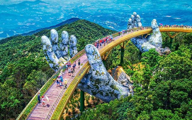 The Golden Bridge in Da Nang, Vietnam, with giant hands reaching out from the mountains.