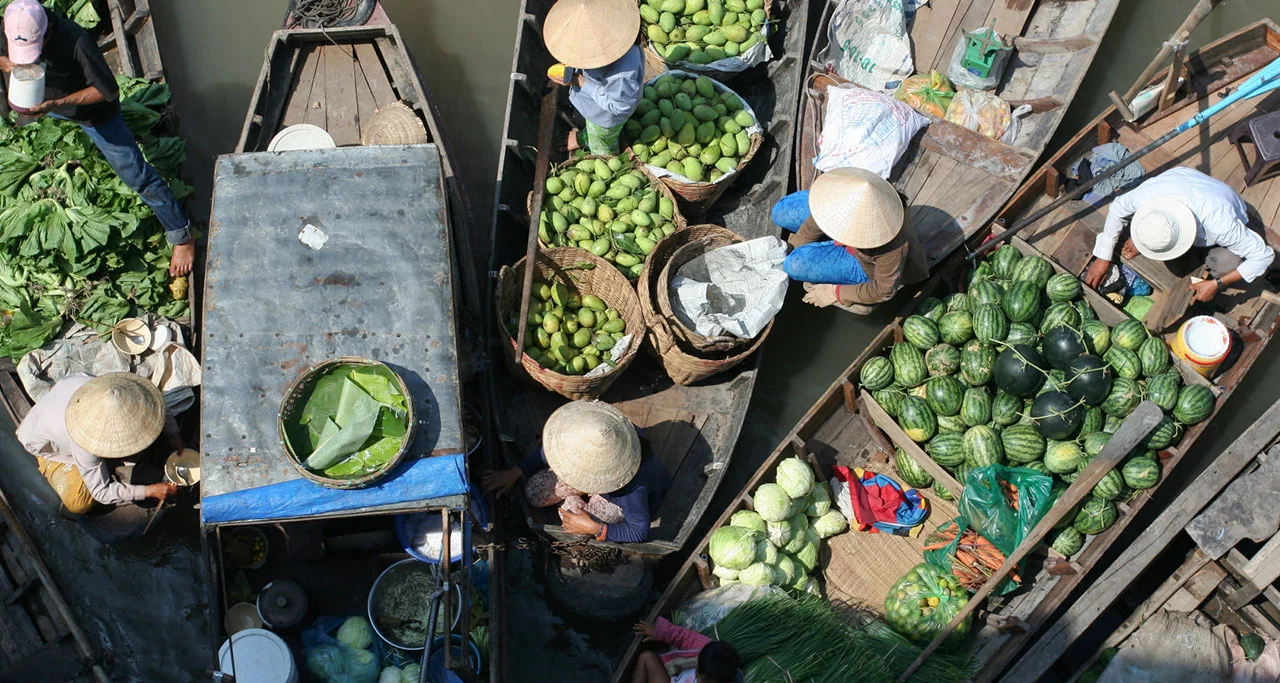 Fruits and vegetables are loaded in the boats for trading in floating markets
