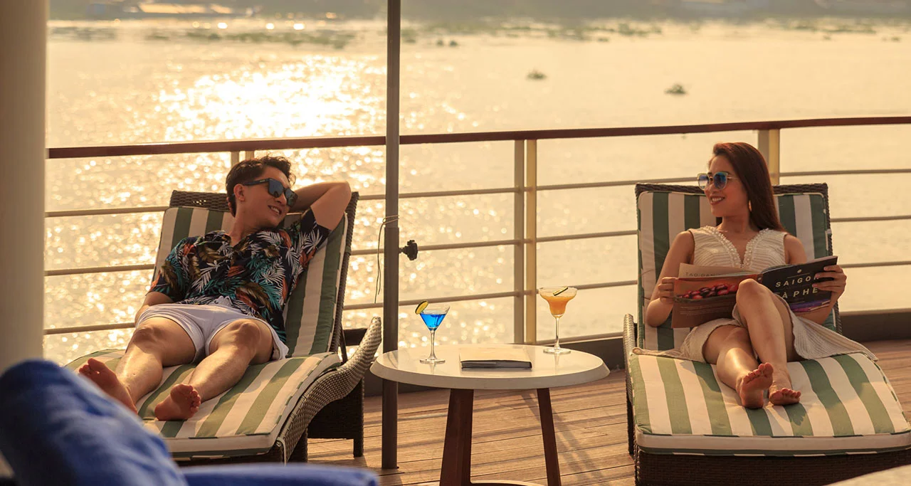 Tourists enjoy stunning sunset on a Mekong Cruise - an interesting experience