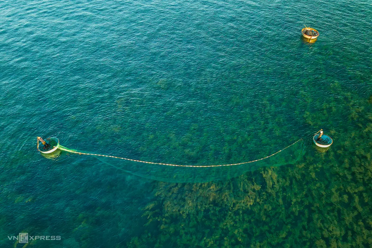 A couple putting fishing net into the sea in Quang Ngai