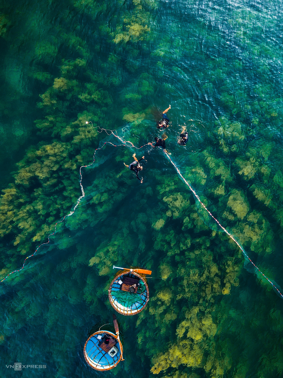 A group of 4 people on 2 basket boats fishing squid