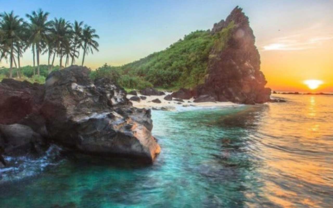 A view of a beach with volcanic rocks and blue water in Ly Son Island in Quang Ngai