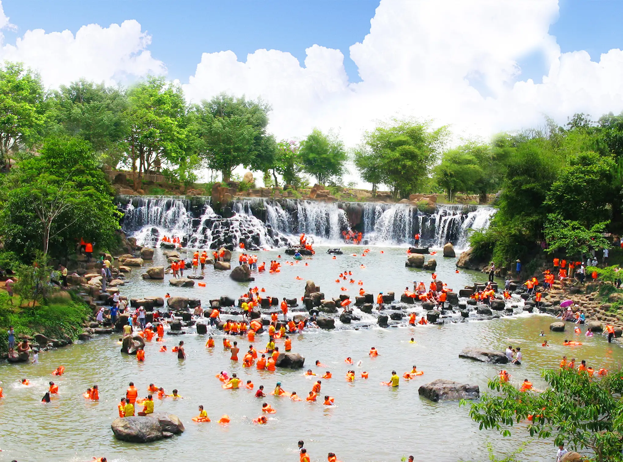 A group of tourists having fun swimming at Giang Dien Waterfall