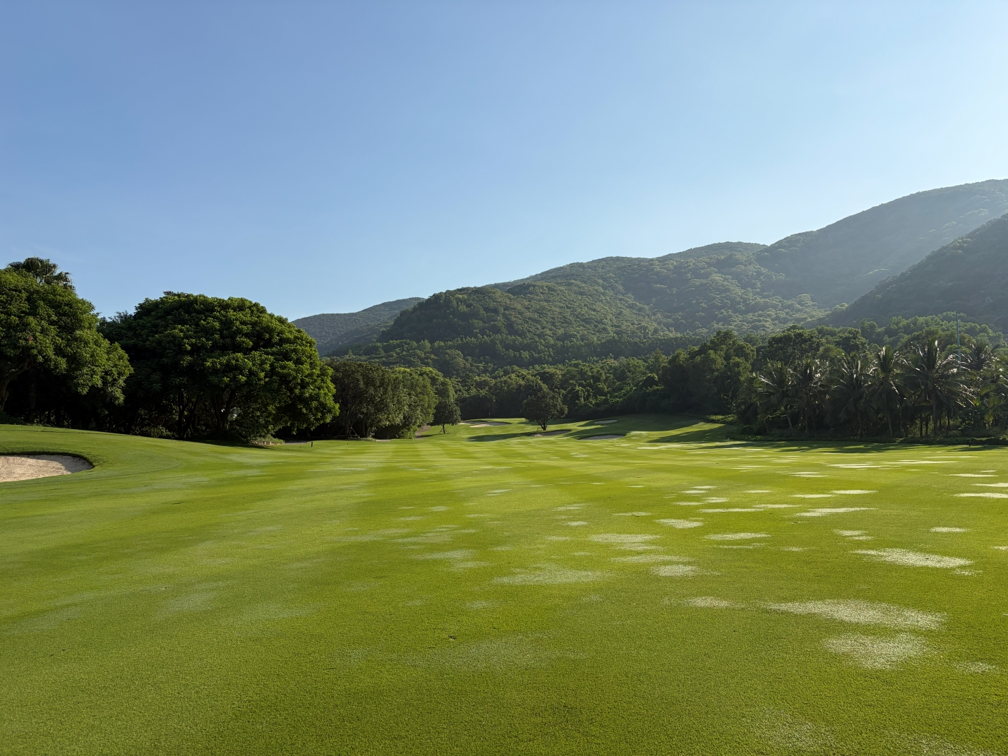 Wide fairway at Vinpearl Golf Nha Trang with green hills in the background